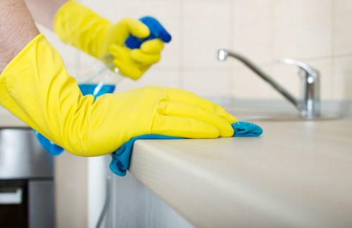 Trained cleaner using professional carpet cleaning equipment safely